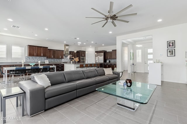 tiled living room with ceiling fan