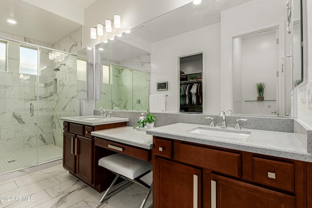 bathroom with vanity and a shower with door