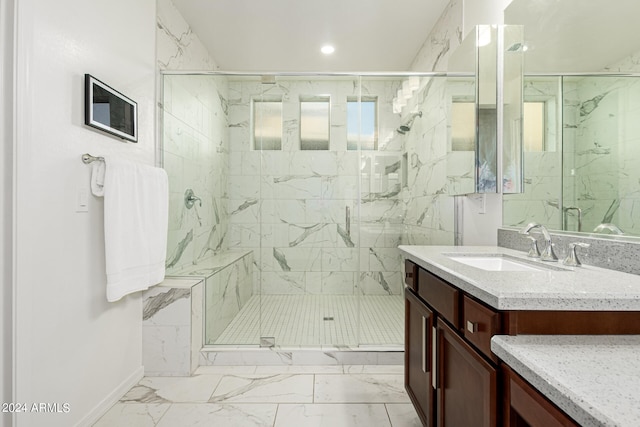 bathroom with a shower with door and vanity