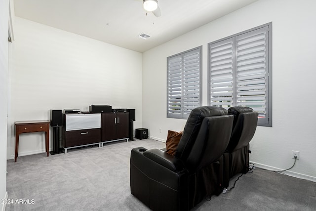 sitting room featuring light colored carpet and ceiling fan