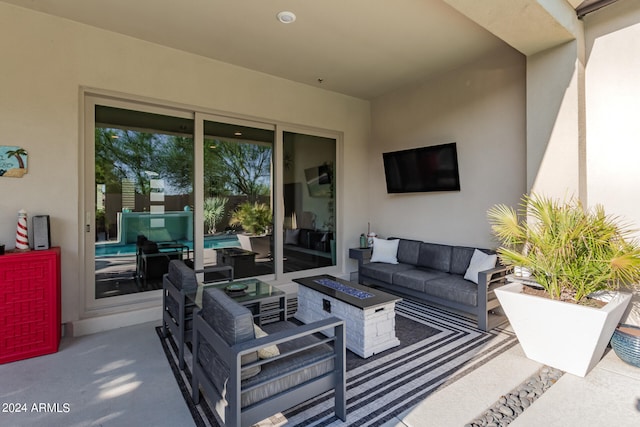 view of patio / terrace featuring an outdoor living space with a fire pit