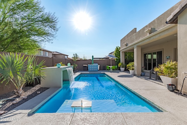 view of pool featuring pool water feature and a patio