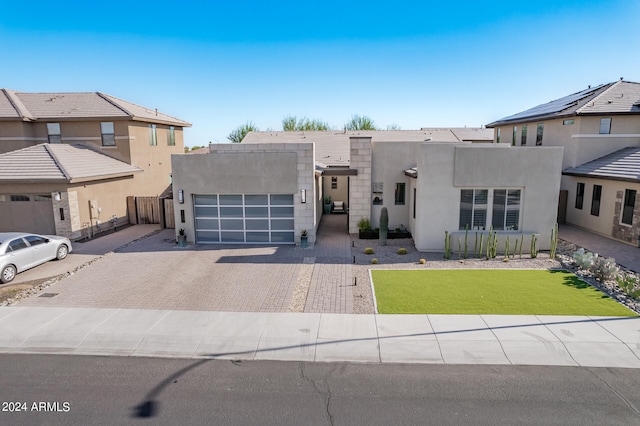 view of front of home featuring a front lawn and a garage