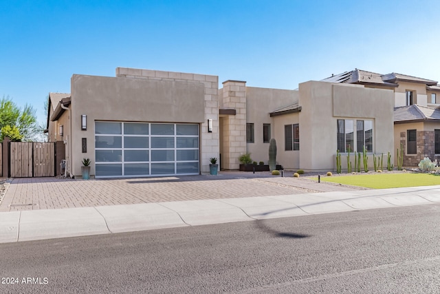 pueblo revival-style home featuring a garage