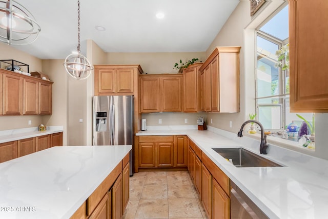 kitchen featuring hanging light fixtures, appliances with stainless steel finishes, and sink