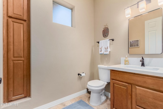 bathroom featuring vanity, toilet, and tile patterned flooring