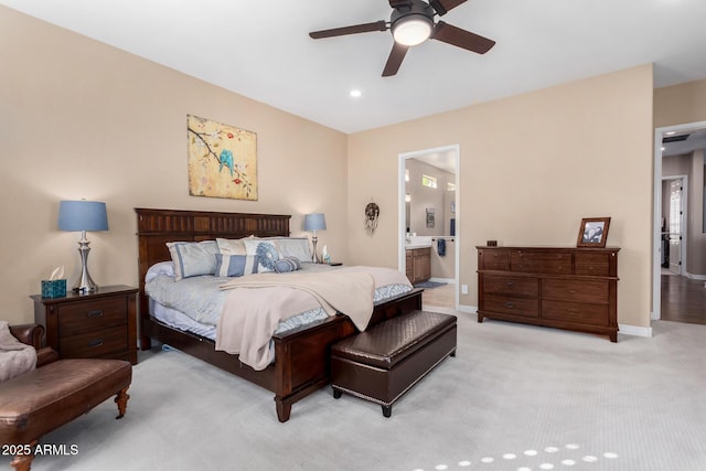 carpeted bedroom featuring ceiling fan and ensuite bath