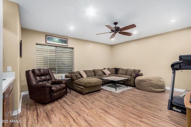 living room with ceiling fan and light hardwood / wood-style floors