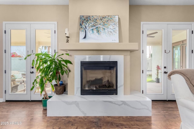 living room with french doors and dark wood-type flooring