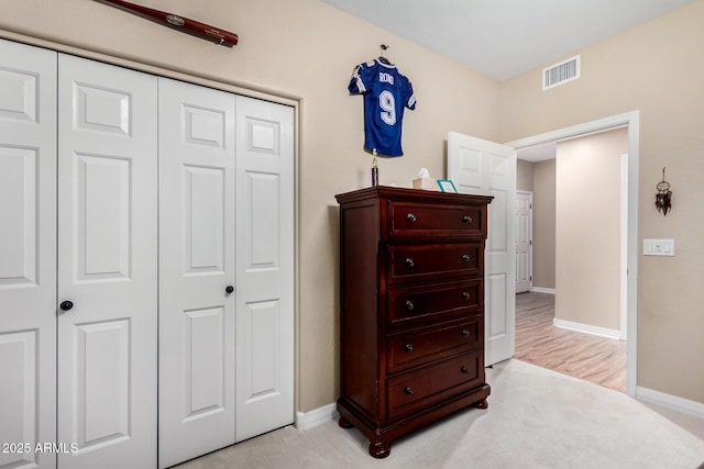 carpeted bedroom with a closet