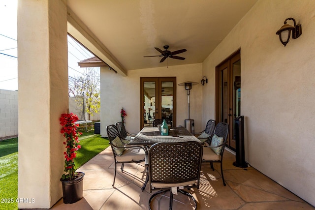 view of patio / terrace featuring ceiling fan and french doors