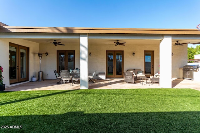 back of house with a patio, a yard, and french doors