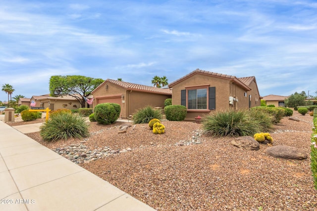 19722 N Regents Park Dr, Surprise, AZ 85387 - view of front of property featuring an attached garage, a tiled roof, and stucco siding