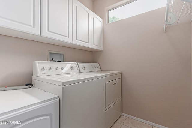 19722 N Regents Park Dr, Surprise, AZ 85387 - laundry room featuring independent washer and dryer, cabinet space, light tile patterned floors, and baseboards