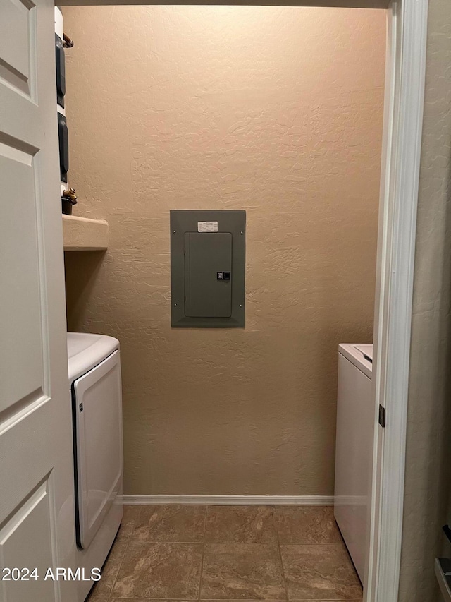 laundry area with washing machine and dryer and electric panel