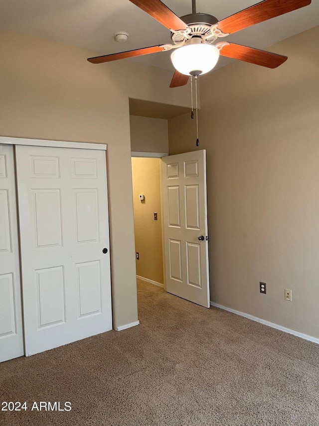 unfurnished bedroom with a closet, ceiling fan, and carpet flooring