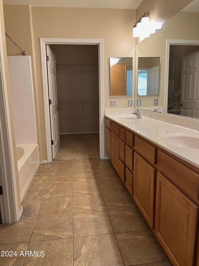 bathroom with vanity and a bath