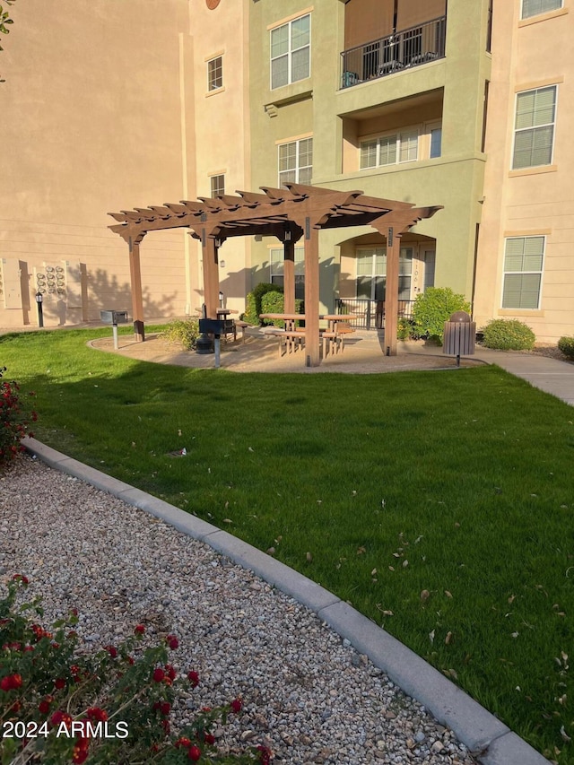 view of property's community with a patio area, a yard, and a pergola