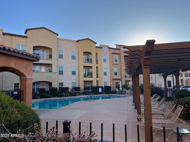 view of swimming pool with a patio and a pergola