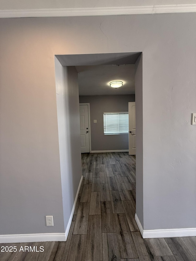 hallway with baseboards and dark wood finished floors