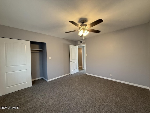 unfurnished bedroom with a ceiling fan, a closet, baseboards, dark colored carpet, and visible vents