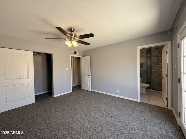 unfurnished bedroom with baseboards, ensuite bath, dark colored carpet, ceiling fan, and visible vents