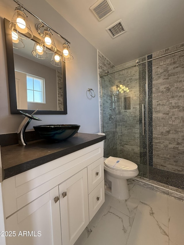 full bathroom featuring a shower stall, toilet, vanity, and visible vents
