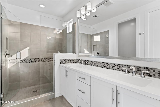 bathroom featuring decorative backsplash, walk in shower, and vanity