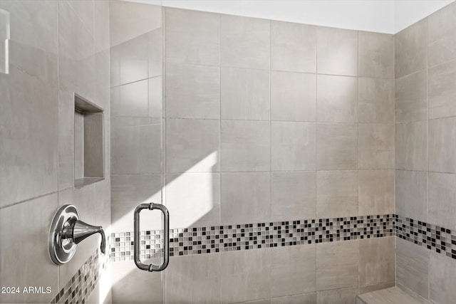 bathroom with tile walls and an enclosed shower