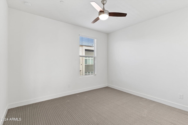 spare room with ceiling fan and carpet