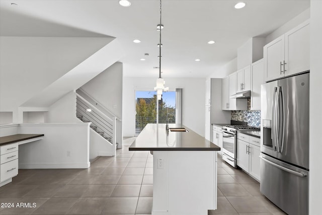 kitchen featuring pendant lighting, a center island with sink, white cabinets, sink, and appliances with stainless steel finishes