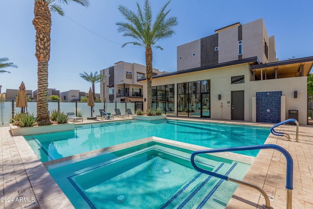 view of pool featuring a patio and a hot tub