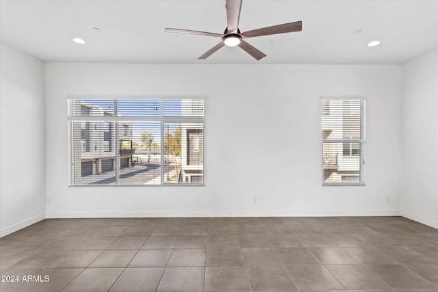 spare room with tile patterned floors and ceiling fan