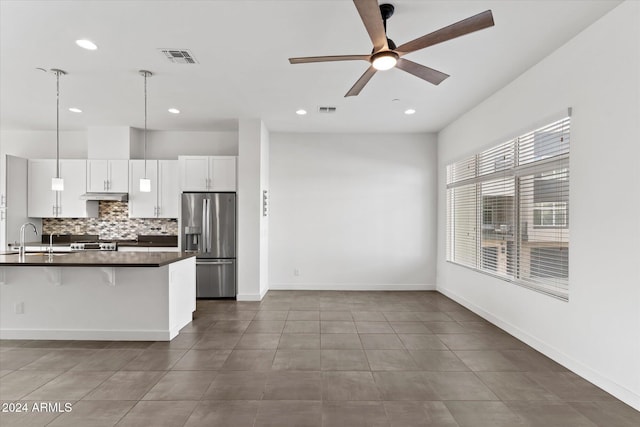 kitchen with white cabinetry, ceiling fan, stainless steel appliances, a kitchen breakfast bar, and pendant lighting