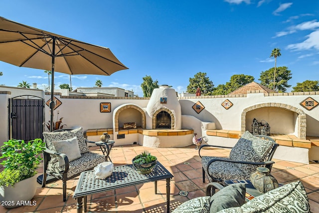 view of patio featuring exterior fireplace