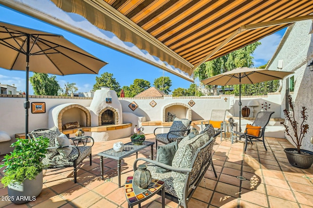 view of patio with an outdoor living space with a fireplace