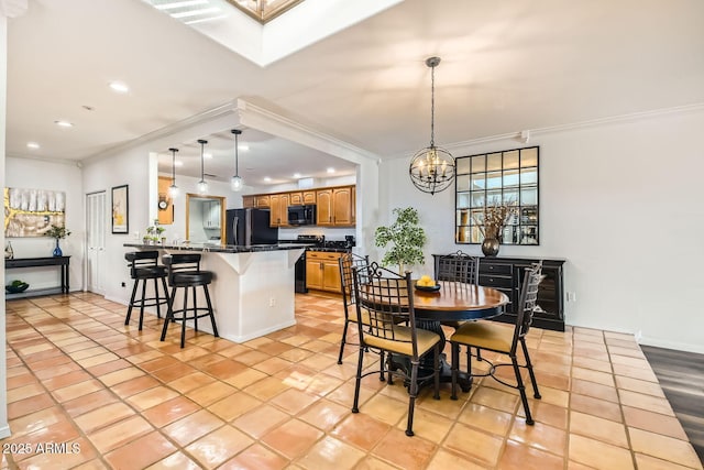 tiled dining room with a notable chandelier, crown molding, and a skylight