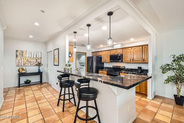 kitchen with pendant lighting, a breakfast bar area, black refrigerator, range with electric cooktop, and kitchen peninsula