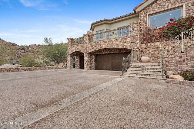 view of front of house featuring a garage and a balcony