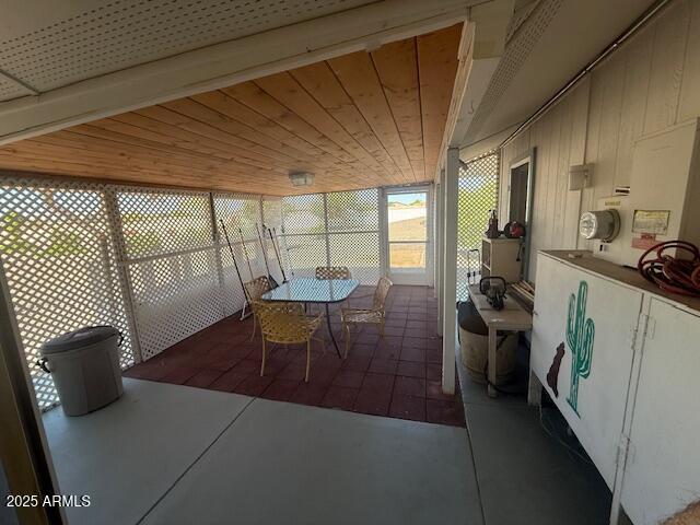 sunroom / solarium featuring outdoor dining area