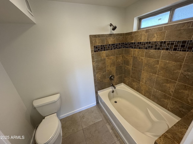 bathroom featuring tile patterned floors, toilet, and washtub / shower combination