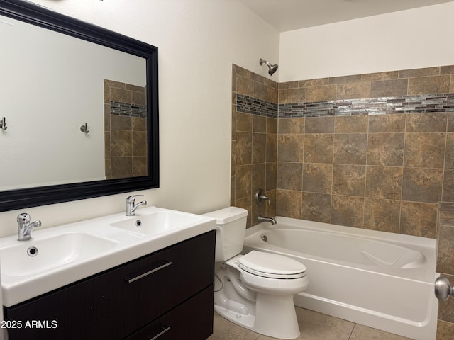 full bathroom featuring vanity, tile patterned floors, toilet, and tiled shower / bath