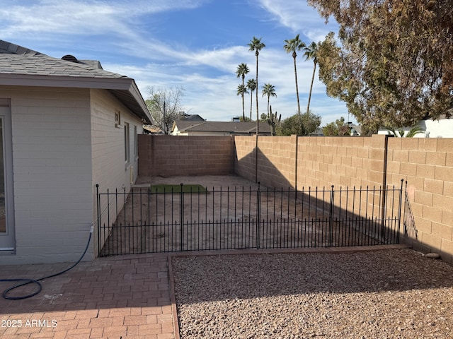 view of gate with a patio area