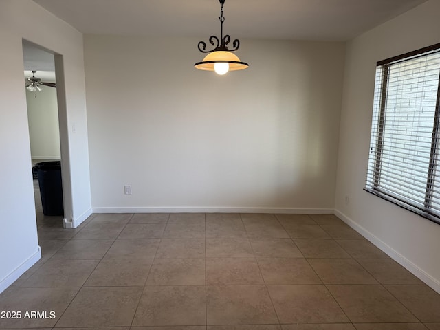 tiled empty room with plenty of natural light and ceiling fan