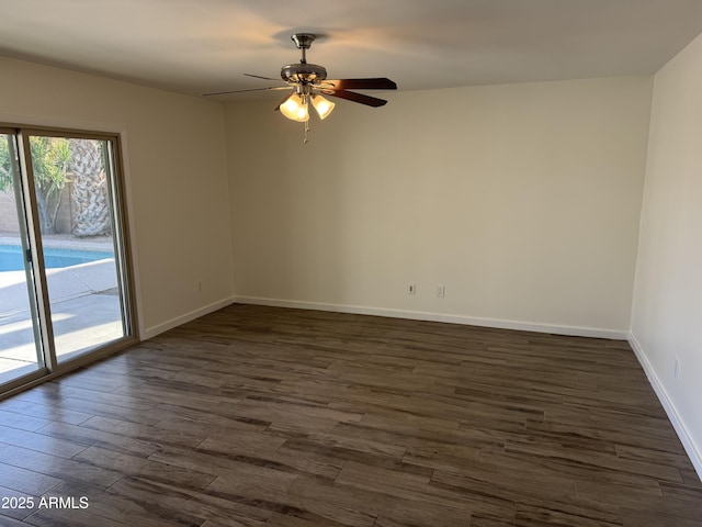 empty room featuring dark wood-type flooring and ceiling fan