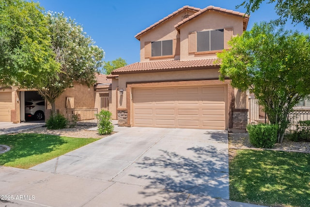 931 S Racine Ln, Gilbert, AZ 85296 - mediterranean / spanish-style home featuring stucco siding, concrete driveway, a tile roof, and a garage