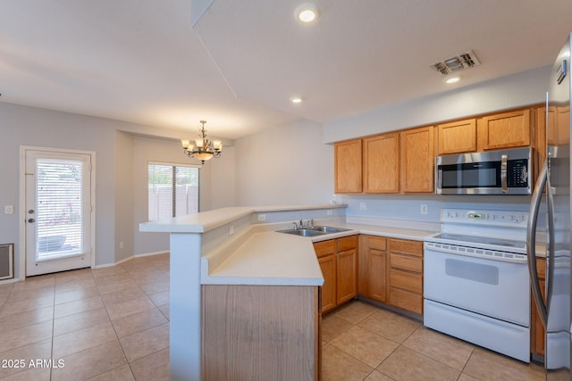 931 S Racine Ln, Gilbert, AZ 85296 - kitchen featuring appliances with stainless steel finishes, a peninsula, light tile patterned floors, a chandelier, and light countertops