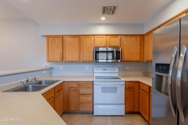 931 S Racine Ln, Gilbert, AZ 85296 - kitchen with stainless steel appliances, light countertops, and light tile patterned floors