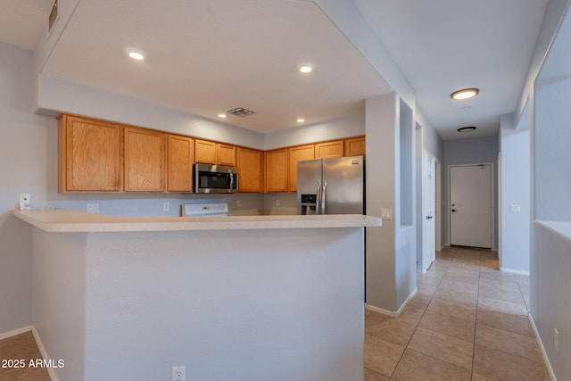 931 S Racine Ln, Gilbert, AZ 85296 - kitchen with stainless steel appliances, a peninsula, light countertops, light tile patterned floors, and recessed lighting