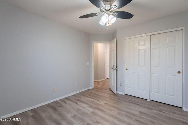 931 S Racine Ln, Gilbert, AZ 85296 - unfurnished bedroom with light wood finished floors, a closet, and a ceiling fan